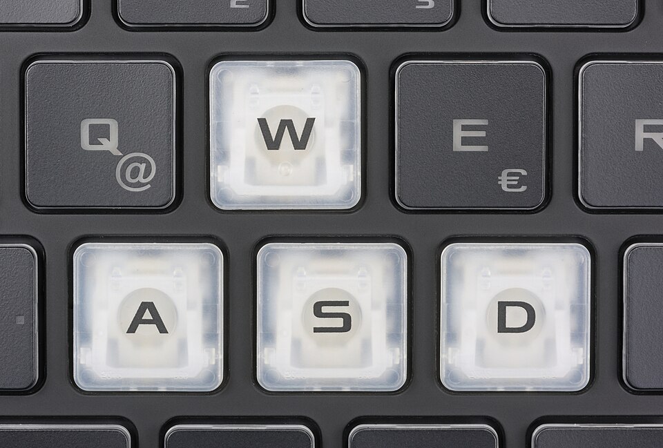 The white WASD keys of a keyboard of an ASUS ROG Strix G15 (G513QY-HQ012T) laptop